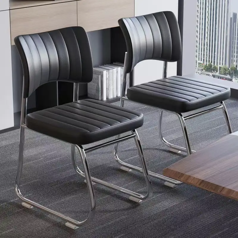 Black leather sled base chair with a metal frame in a modern conference room