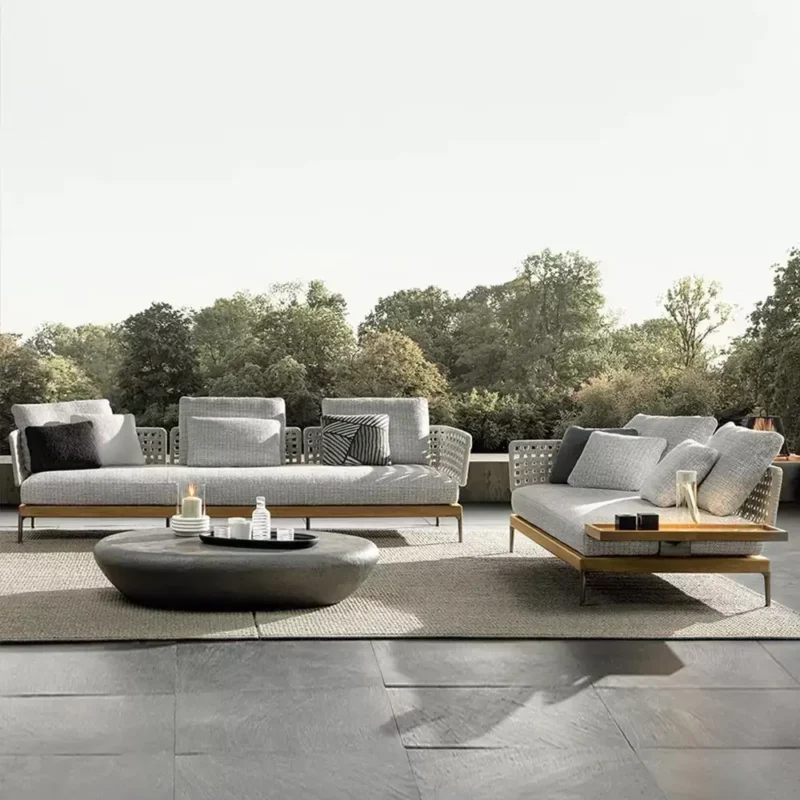 Premium teak outdoor sofa with grey waterproof cushions on a luxury villa patio